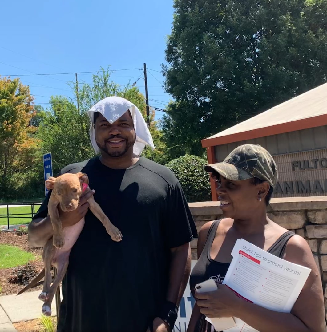 big guy holding a puppy