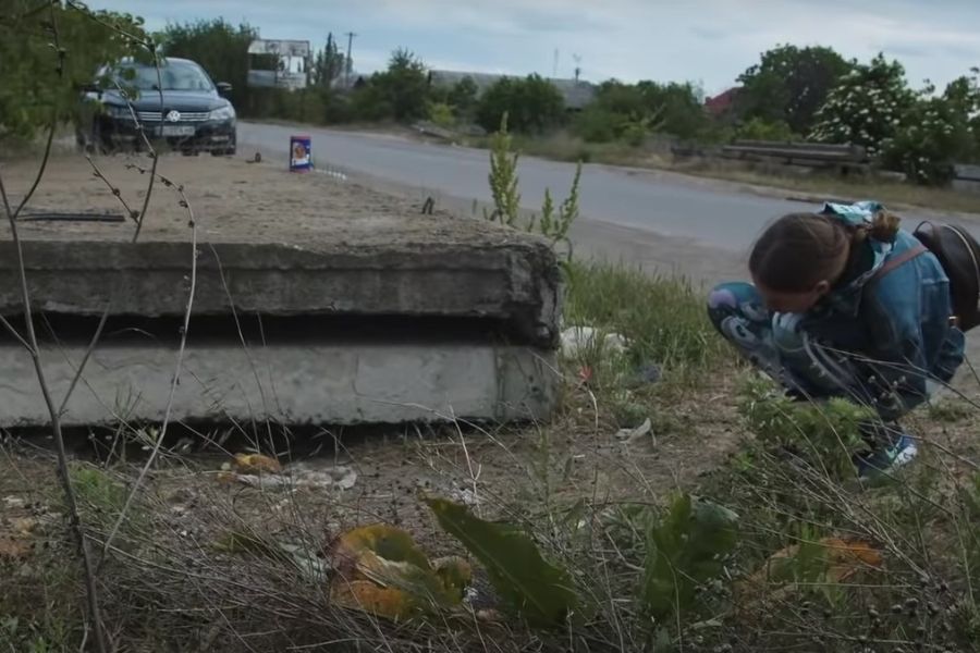 woman looking under concrete slab